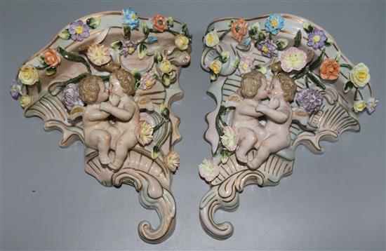 A pair of cherub wall pockets
